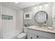 Bathroom with a white vanity, granite countertop, tub, and artistic tile at 6415 Midnight Pass Rd # 502, Sarasota, FL 34242