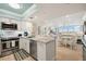 Bright, open kitchen with granite countertops and stainless steel appliances overlooking the dining and living areas at 6415 Midnight Pass Rd # 502, Sarasota, FL 34242