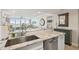 Kitchen with white countertops, undermount sink, stainless dishwasher, and view into living area and bedroom at 6415 Midnight Pass Rd # 502, Sarasota, FL 34242