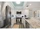 Modern kitchen featuring white cabinetry, granite countertops, and stainless steel appliances at 6415 Midnight Pass Rd # 502, Sarasota, FL 34242