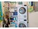 Laundry room with stacked washer and dryer, and ample shelving at 6415 Midnight Pass Rd # 502, Sarasota, FL 34242