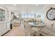 Bright living room with a glass table, ample seating and an impressive ocean view from the large windows at 6415 Midnight Pass Rd # 502, Sarasota, FL 34242