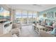 Comfortable living room with large windows and neutral colors and balcony access at 6415 Midnight Pass Rd # 502, Sarasota, FL 34242