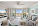 Comfortable living room with large windows and sliding doors to the balcony at 6415 Midnight Pass Rd # 502, Sarasota, FL 34242
