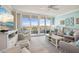 Bright living room with water views and comfortable seating, balcony access at 6415 Midnight Pass Rd # 502, Sarasota, FL 34242