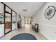 Hallway in the lobby with seating, nautical decorations, tile floor, and office at 6415 Midnight Pass Rd # 502, Sarasota, FL 34242