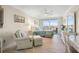 Comfortable bedroom featuring a waterfront view, desk, and chair at 6415 Midnight Pass Rd # 502, Sarasota, FL 34242
