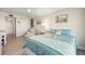 Bright main bedroom with light wood floors, a daybed, and balcony access at 6415 Midnight Pass Rd # 502, Sarasota, FL 34242