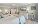 Bright bedroom with white dresser, light wood floors and a comfortable lounge chair at 6415 Midnight Pass Rd # 502, Sarasota, FL 34242