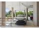 Assigned covered parking area with a parked car and a view of tropical landscaping at 6415 Midnight Pass Rd # 502, Sarasota, FL 34242