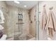 Modern bathroom shower featuring stylish tile, a glass door, and built-in storage niche at 6415 Midnight Pass Rd # 502, Sarasota, FL 34242
