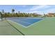Bright blue and green tennis courts surrounded by palm trees offer an active lifestyle at 6415 Midnight Pass Rd # 502, Sarasota, FL 34242