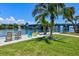 Relaxing waterfront seating area with colorful chairs and scenic views of the bridge and water at 6415 Midnight Pass Rd # 502, Sarasota, FL 34242