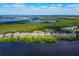 Stunning aerial view showcasing the community's waterfront location, lush landscaping and beautiful homes at 65 Tidy Island Blvd, Bradenton, FL 34210