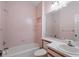 Cozy bathroom features pink tile, a vanity with sink, and a combined tub and shower at 65 Tidy Island Blvd, Bradenton, FL 34210