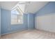 Cozy bedroom featuring a window, ceiling fan, and closet with painted blue walls and neutral carpet at 65 Tidy Island Blvd, Bradenton, FL 34210