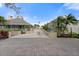 Community clubhouse with pavers, multiple ramps and sidewalks, and tropical landscaping at 65 Tidy Island Blvd, Bradenton, FL 34210