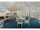 Clubhouse interior with vaulted ceilings, seating areas with blue carpeting, and lots of natural light at 65 Tidy Island Blvd, Bradenton, FL 34210