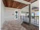 Covered front entrance featuring a brick wall, wooden ceiling, and decorative iron gate at 65 Tidy Island Blvd, Bradenton, FL 34210