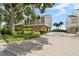 Beautiful two-story house with mature landscaping and a brick driveway at 65 Tidy Island Blvd, Bradenton, FL 34210