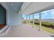 Bright sunroom with tiled floor and many windows overlooking the lush yard at 65 Tidy Island Blvd, Bradenton, FL 34210