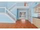 Bright living room features hardwood floors, an open staircase, and access to additional rooms at 65 Tidy Island Blvd, Bradenton, FL 34210