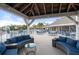 Inviting outdoor lounge area with blue seating under a pavilion with tables and pool views at 65 Tidy Island Blvd, Bradenton, FL 34210