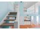 View of the staircase, loft, wet bar, and kitchen in an open concept living space at 65 Tidy Island Blvd, Bradenton, FL 34210