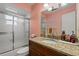 This bathroom features a granite countertop with a sink, a shower with sliding doors at 6916 W Country Club N Dr # 9B, Sarasota, FL 34243