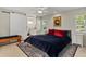 Inviting main bedroom with a sliding barn door to ensuite bath, natural light, and plush bedding at 6916 W Country Club N Dr # 9B, Sarasota, FL 34243