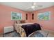 This bedroom has a unique coral paint color and lots of natural light at 6916 W Country Club N Dr # 9B, Sarasota, FL 34243