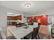The dining room features a bright chandelier and an open concept view into the kitchen and living room at 6916 W Country Club N Dr # 9B, Sarasota, FL 34243