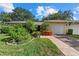 Charming home featuring a well-manicured lawn, garden, brick pathway, and a one-car garage at 6916 W Country Club N Dr # 9B, Sarasota, FL 34243