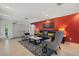 The living room features tile floors, comfortable seating, and a red accent wall at 6916 W Country Club N Dr # 9B, Sarasota, FL 34243
