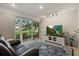 Cozy living room features a large flat-screen TV, comfortable seating, and sliding glass doors at 6916 W Country Club N Dr # 9B, Sarasota, FL 34243