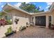 The brick-paved patio features neutral stucco walls with hanging plants and seating for outdoor enjoyment at 6916 W Country Club N Dr # 9B, Sarasota, FL 34243