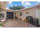 The brick-paved patio features neutral stucco walls with a BBQ, and seating for outdoor enjoyment at 6916 W Country Club N Dr # 9B, Sarasota, FL 34243
