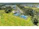An aerial view of the tennis and basketball courts. The pool and clubhouse are in the background at 7160 Amelia River Dr, Parrish, FL 34219