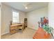 A simple bedroom features a desk area, a desk and a wooden side table at 7160 Amelia River Dr, Parrish, FL 34219