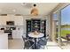 Breakfast nook with a round table, decorative shelving, and sliding glass doors leading to the backyard at 7160 Amelia River Dr, Parrish, FL 34219