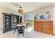 A view of a dining area with a lake view, decorative shelving and a vintage dresser at 7160 Amelia River Dr, Parrish, FL 34219