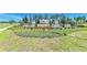 Salt Meadows community entrance featuring a landscaped sign, stone pillars, and well-maintained vegetation at 7160 Amelia River Dr, Parrish, FL 34219