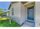 Close-up of the home's entrance, showcasing the front door, stone accents and landscaping at 7160 Amelia River Dr, Parrish, FL 34219