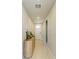Inviting hallway featuring tile floors, neutral paint and decorative accents at 7160 Amelia River Dr, Parrish, FL 34219