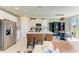 Open-concept kitchen features a center island with seating, stainless steel appliances and ample cabinet space at 7160 Amelia River Dr, Parrish, FL 34219