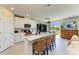 Modern kitchen with white cabinets, a center island, and seating with a water view at 7160 Amelia River Dr, Parrish, FL 34219
