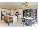 Bright kitchen features a center island with bar stool seating and an adjacent dining area with decorative shelving at 7160 Amelia River Dr, Parrish, FL 34219