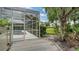 Enjoy backyard access from a side-entry door and screened-in lanai to a lush backyard at 8239 Cypress Hollow Dr, Sarasota, FL 34238
