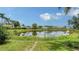 A serene backyard and pond provide a relaxing view with lush landscaping at 8239 Cypress Hollow Dr, Sarasota, FL 34238