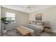 Cozy bedroom with modern decor, featuring a comfortable bed with stylish linens, a window, and a decorative plant at 8239 Cypress Hollow Dr, Sarasota, FL 34238